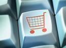 Shopping trolley on button of computer keyboard